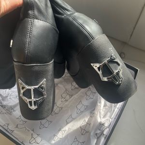 Naked wolf platform heeled black boots.
